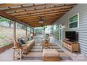 Inviting covered patio featuring comfortable seating and a ceiling fan at 392 Winecoff Woods Nw Dr, Concord, NC 28027