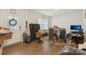 View of home entryway with door, wood flooring, and cluttered furniture at 3985 Village Nw Blvd, Conover, NC 28613