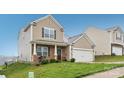 Charming two-story home with a brick-accented porch and attached two-car garage at 3985 Village Nw Blvd, Conover, NC 28613
