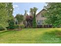 Inviting single-story home with lush landscaping and manicured lawn, set on a sunny day at 4018 Harmattan Dr, Denver, NC 28037