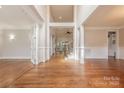 Spacious foyer features pristine hardwood floors and elegant white columns with views of the second story at 4113 Hoffmeister Dr, Waxhaw, NC 28173