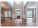 Foyer features hardwood floors, soaring ceilings, and a decorative wood front door at 4113 Hoffmeister Dr, Waxhaw, NC 28173