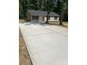 Home exterior with a wide concrete driveway and new landscaping at 507 Putter Pl, Chester, SC 29706