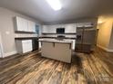 Spacious kitchen with white cabinets, stainless steel appliances, and island at 507 Putter Pl, Chester, SC 29706