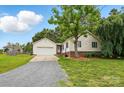 Inviting single-story home featuring attached garage, vinyl siding, and lush landscaping at 5359 Lake Glenn Dr, Stanfield, NC 28163