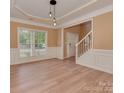 Dining room with wainscoting and a view of the foyer and staircase at 5607 Fulton Ridge Dr, Indian Trail, NC 28079