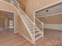 Inviting foyer with a staircase, wood floors, and views into the formal dining room and another room at 5607 Fulton Ridge Dr, Indian Trail, NC 28079