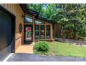 Inviting entrance with large windows, black trim, and colorful welcome decor, showcasing a blend of modern and classic design at 6119 Bittersweet Ln, Charlotte, NC 28270