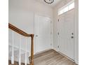 Bright foyer featuring wood-look floors and a staircase with a wooden handrail at 622 Bayou Cir, Clover, SC 29710