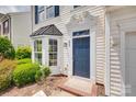 Close up view of a blue front door with elegant trim, and neat landscaping at 622 Bayou Cir, Clover, SC 29710