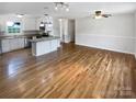 Bright and airy living space with hardwood floors connecting the living area to the modern kitchen at 7308 Pleasant Hill Church Rd, Marshville, NC 28103