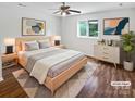 Comfortable bedroom with a light wood bed frame, soft rug, and decorative art at 7308 Pleasant Hill Church Rd, Marshville, NC 28103