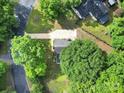 An aerial view of a home featuring a long driveway, mature trees, and a lush green lawn at 8514 Timber Crest Cir, Charlotte, NC 28226