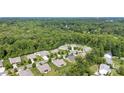 Aerial view showcases a lush green neighborhood with well-maintained lawns and mature trees surrounding residences at 8840 Mullis Forest Ct, Mint Hill, NC 28227