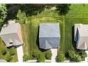 Aerial view of the house shows the roof and the grassy yard with surrounding trees and neighboring homes at 8840 Mullis Forest Ct, Mint Hill, NC 28227