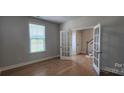 Sunlit home office with hardwood floors, french doors, and bright window views at 885 Regulus Ct # 42, York, SC 29745