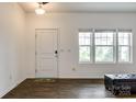 Bright entryway with hardwood floors, white door, and natural light from the adjacent windows at 922 Bunker Trce, Rock Hill, SC 29730