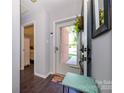 Bright foyer with dark hardwood floors, light gray walls and decorative accents at 9239 N Vicksburg Park Ct, Charlotte, NC 28210