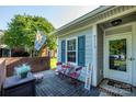Inviting front porch with quaint seating, brick detail, and a welcoming entrance at 9239 N Vicksburg Park Ct, Charlotte, NC 28210