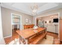Bright dining room featuring a wooden table, stylish chandelier, and hardwood floors at 105 Banksridge Rd, Fort Mill, SC 29715