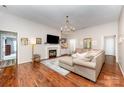 Bright living room with hardwood floors, fireplace, and stylish chandelier at 105 Banksridge Rd, Fort Mill, SC 29715
