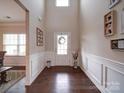 Bright foyer with hardwood floors, high ceilings, decorative wreath, and white wainscoting at 114 Sierra Chase Dr, Statesville, NC 28677