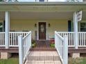 Inviting front porch with beautiful planters flanking a decorative front door and welcome sign at 11850 Sugar Hill Rd, Davidson, NC 28036