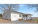 A one story home with white siding and an attached two car garage at 12491 Oak Grove Rd, Stanley, NC 28163