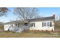Charming ranch home featuring a covered front porch and mature landscaping at 12491 Oak Grove Rd, Stanley, NC 28163