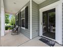 Relaxing front porch with seating area and a clear view to the outside, accessible through the glass front door at 13107 Heath Grove Dr, Huntersville, NC 28078