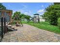 Spacious backyard features a stone patio and a fun playset, perfect for outdoor entertainment and recreation at 1609 Troy Rd, Shelby, NC 28150