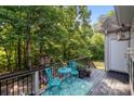 Relaxing outdoor deck with table, chairs, and views of the lush trees at 161 Dairy Farm Rd, Mooresville, NC 28115