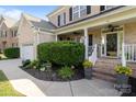 Charming front porch with brick steps, decorative planters, and manicured bushes at 161 Dairy Farm Rd, Mooresville, NC 28115