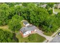 A stunning aerial view of a home surrounded by dense, mature trees and a detached garage at 1822 N New Hope Rd, Gastonia, NC 28054