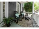 Inviting front porch features rocking chairs with plush cushions and a stylish patterned rug at 189 Mills Ln, Fort Mill, SC 29708
