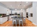 Bright kitchen featuring white cabinetry, dark countertops, stainless steel appliances, and an island with seating at 189 Mills Ln, Fort Mill, SC 29708