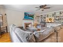 Cozy living room with a brick fireplace, built-in shelving, and a comfortable gray sofa at 211 General Stonewall Jackson Dr, Stanley, NC 28164