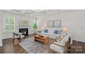 Bright living room boasts coffered ceilings, fireplace, and stylish decor at 2185 Loire Valley Dr, Fort Mill, SC 29707