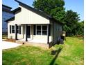 Exterior view of new home with neutral siding, black accents, and well-maintained lawn at 256 Lincoln Sw St # 1, Concord, NC 28025