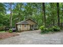 View of the house's side featuring a cozy deck in a private, wooded lot with mature trees at 3000 Low Gap Rd, Waxhaw, NC 28173