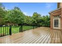 Spacious wooden back deck overlooking a lush, well-maintained backyard with mature trees at 3206 Lakehurst Xing, Matthews, NC 28104