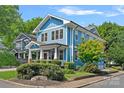 Beautiful blue two-story home with manicured landscaping and a classic architectural design at 331 Solomon St, Charlotte, NC 28216