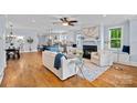 Open-concept living room with hardwood floors, fireplace, and seamless flow to the kitchen at 331 Solomon St, Charlotte, NC 28216
