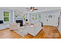 Bright and airy living room featuring a fireplace, hardwood floors, and large windows at 331 Solomon St, Charlotte, NC 28216