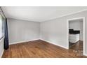 A bright living room featuring hardwood floors, neutral walls, and natural light at 405 N Woodland Dr, Lancaster, SC 29720