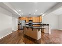 Well-lit kitchen with stainless steel appliances, black countertops, and center island at 4095 Harmattan Dr, Denver, NC 28037