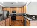 Well-lit kitchen with stainless steel appliances, black countertops, and lots of cabinet space at 4095 Harmattan Dr, Denver, NC 28037