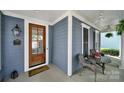 Inviting covered front porch with a wooden door, seating area, and decorative accents at 436 Third Baxter St, Fort Mill, SC 29708