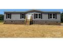 Front exterior view of a charming gray home with black shutters at 493 Eagle Mills Rd, Hamptonville, NC 27020