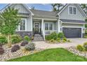 Inviting front entrance with well-maintained lawn, stone accents, and a cozy front porch with lovely landscaping at 562 Preservation Dr, Fort Mill, SC 29715